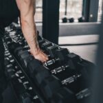A man holding a gym equipment in a gym
